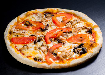 fresh italian pizza on black background