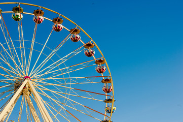 Close up ferris wheel with a blue sky background