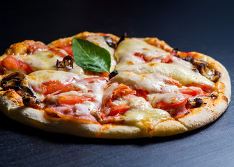 fresh italian pizza on black background