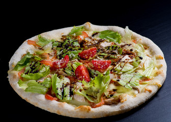 fresh italian pizza on black background