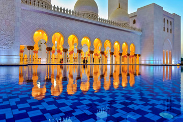 Reflections of the golden walkway inside the Sheikh Zayed Mosque or the grand Mosque during evening