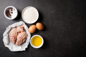 Raw brains and ingredients for cooking fried brains on stone dark table. Calf or beef brains. Gourmet food. Top view, copy space