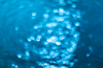 abstract blue background with bokeh lights. Defocused or blurred blue water background.