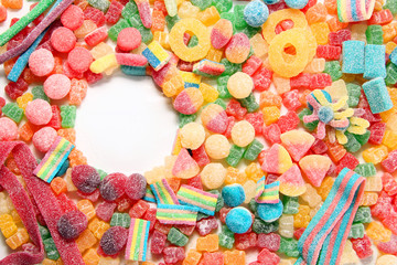 Assorted variety of sour candies includes extreme sour soft fruit chews, keys, tart candy belts and straws.