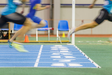 Sportsmen running out finish line in sprint.