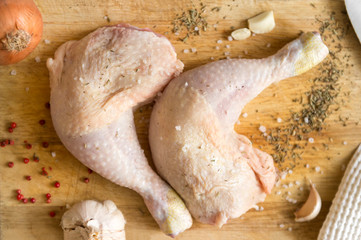 raw chicken legs with spices on cutting Board, chicken meat