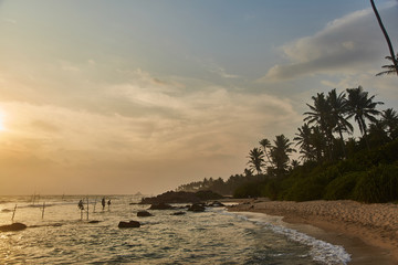 Naklejka premium Fishermen in Sri Lanka fishing at sunset 