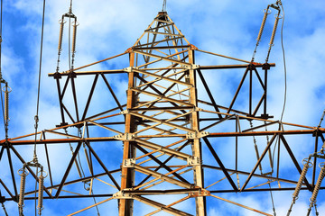 Metal support of high-voltage power line 110 kV. Transmission tower or electricity pylon with blue sky. Fragment
