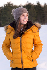 Girl in the yellow jacket on the snow