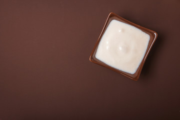 Homemade yogurt in a ceramic square bowl. Healthy food from the concept of yogurt. Top view