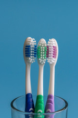 Toothbrushes on blue background. Flat lay composition with manual toothbrushes on color background, close up. vertical photo