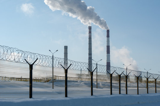industrial chimney and barbed wire