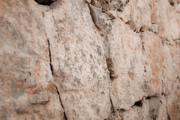 Stone wall of warm tones background