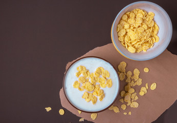 Bowl with flakes in homemade greek yogurt. Healthy food. Breakfast. Top view