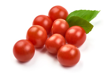 Fresh cherry tomatoes with basil, close-up, isolated on white background