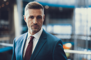 Portrait of handsome man in suit looking at camera