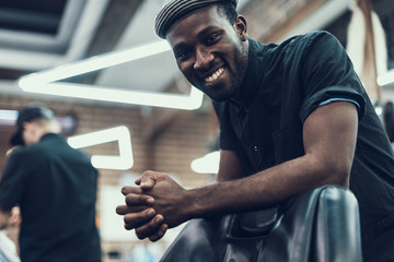 Attractive hairstylist looking at camera and smiling