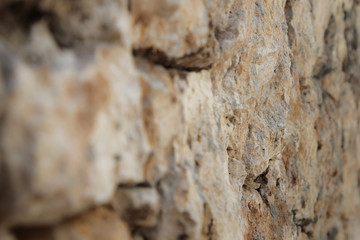 Stone wall of warm tones background
