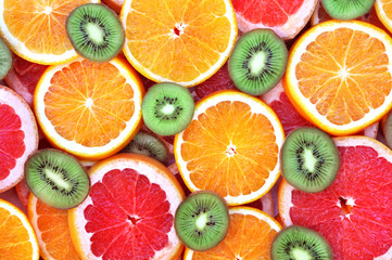 Fresh ripe sweet citrus fruits colorful background: orange, grapefruit, lime, lemon	