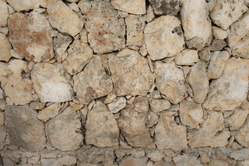 Stone wall of warm tones background