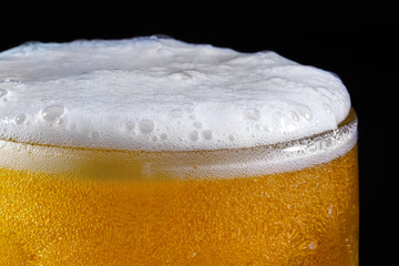 Glass of beer on dark background. Alcoholism concept