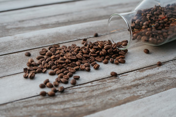 coffee beans spilled on wooden background
