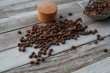 coffee beans spilled on wooden background