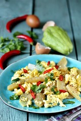 egg chayote in mexican style. whipped eggs are fried with chopped chayote with cilantro and spicy chili. recipe with chayote. top view. Mexican food