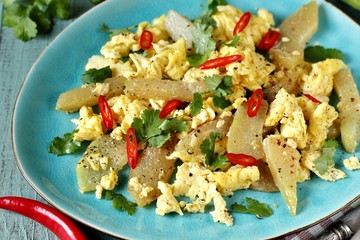 egg chayote in mexican style. whipped eggs are fried with chopped chayote with cilantro and spicy chili. recipe with chayote. top view. Mexican food