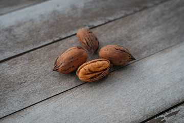 Pecan Walnuts on wooden table.