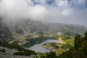 Hut in the misty mountain near lake