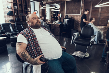 Handsome man siting in barber shop chair