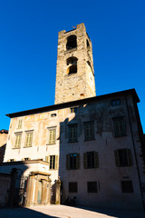 Fototapeta na wymiar Campanone Civic Tower at main square Piazza Vecchia in Upper Medieval Town in Bergamo