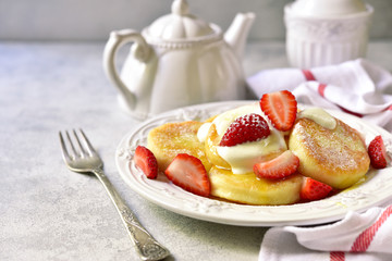 Homemade curd pancakes with vanilla custard and honey.