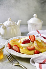 Homemade curd pancakes with vanilla custard and honey.