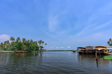 Fototapeta na wymiar River view and traditional house boat in Kerala's Backwaters, India.
