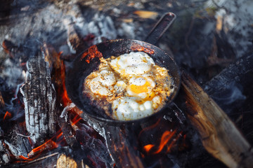 Fried eggs on the pan on the fire in winter
