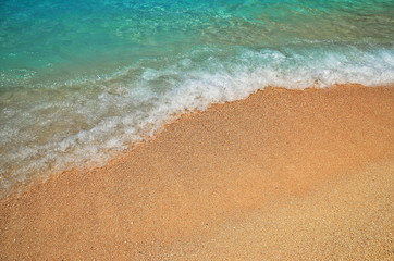 Waves and sea foam on the beach