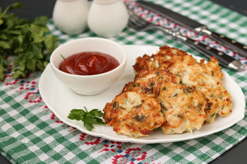 Homemade chicken patties, Chicken fillet is fried and served with tomato sauce on a plate on dark background, Closeup