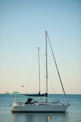 sail Boats anchored near coast on a calm ocean sea