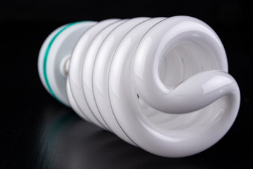 Different light bulbs and fluorescent lights on a wooden table. New types of lighting.