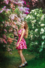 beautiful girl in  lilac spring garden
