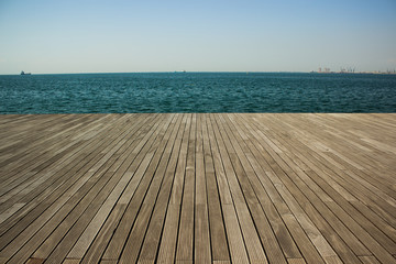 summer sea waterfront shoreline with deck floor perspective foreground foreshortening wooden surface and horizontal panoramic, copy space - Powered by Adobe