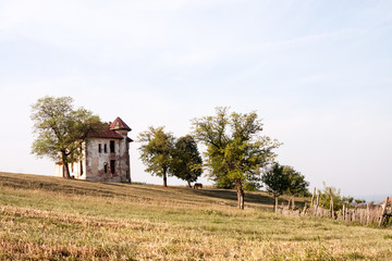 Old, abandoned, ruined house in the field