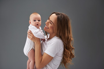 Good-looking mama and little baby with wondered face