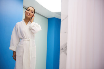 Fototapeta premium Relaxed asian lady walk in corridor of spa salon