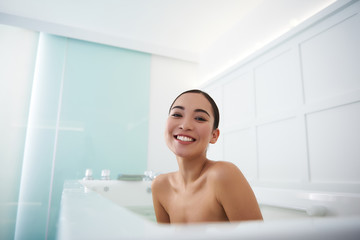 Cheerful asian lady having relax in bath
