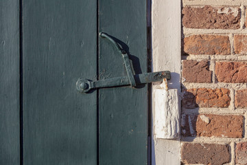 abstract rusty brass brown knocker in a door curch closed wood