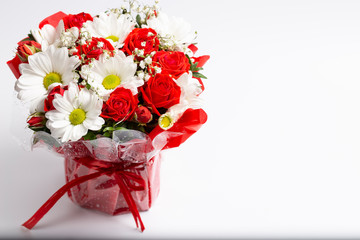 Beautiful designer bouquet of flowers in a beautiful cramped red bucket.Isolated on a white background.