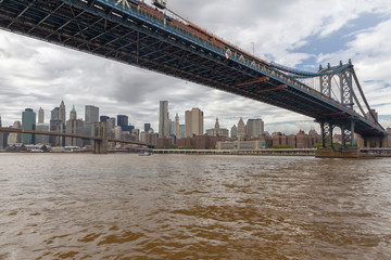 Fototapeta na wymiar View of Lower Manhattan and Brooklyn Bridge skyline on a sunny summer day from Brooklyn's side of East River
